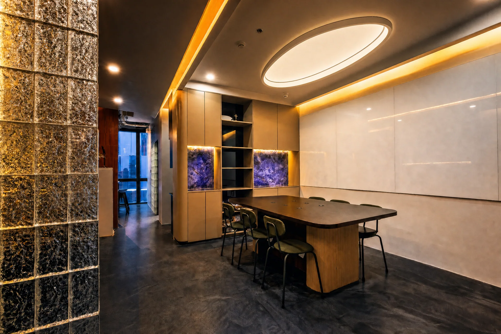 Sundial open workspace with glass blocks, a meeting table, and sculptural ceiling lighting