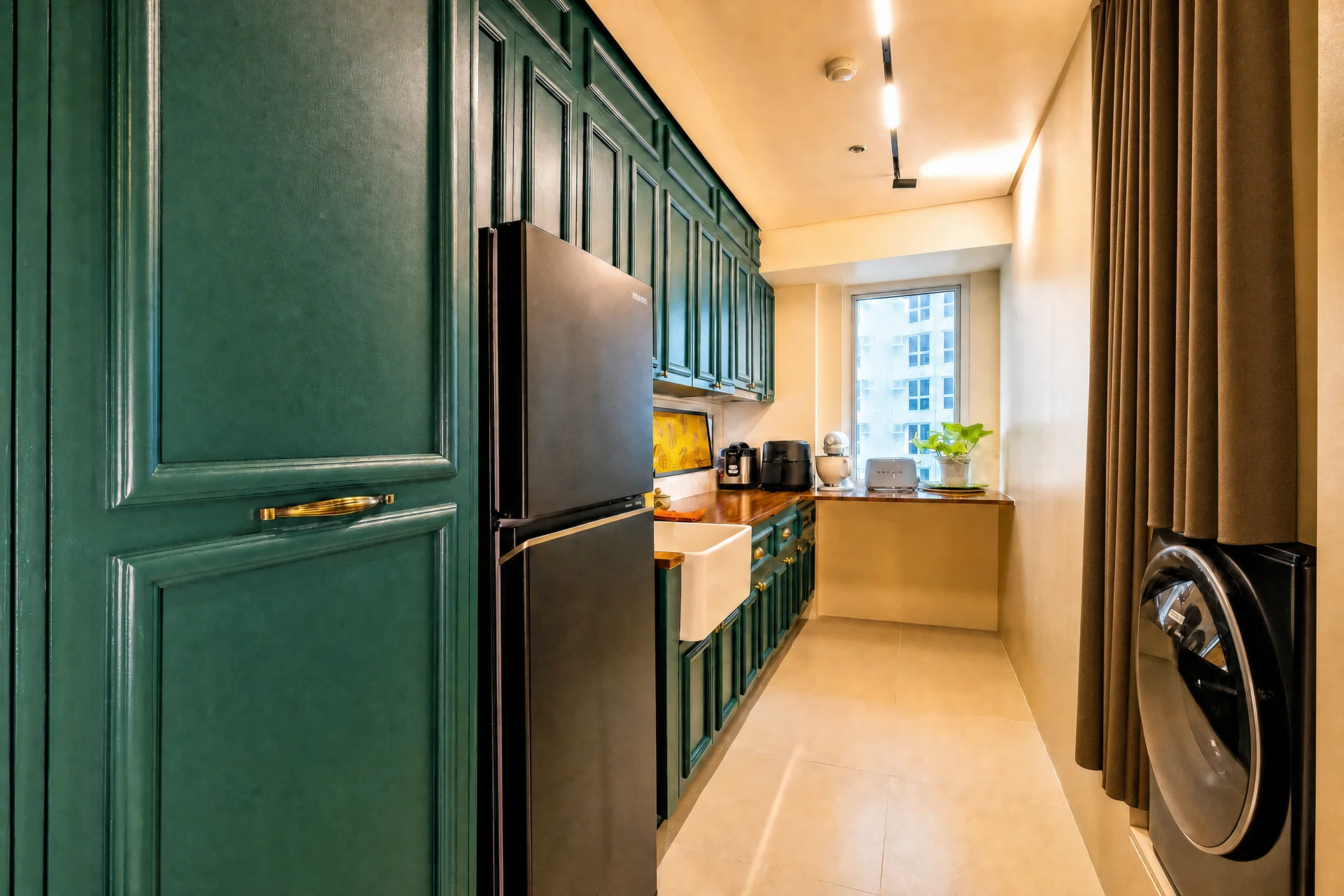 Deep green custom kitchen cabinetry with oak counters