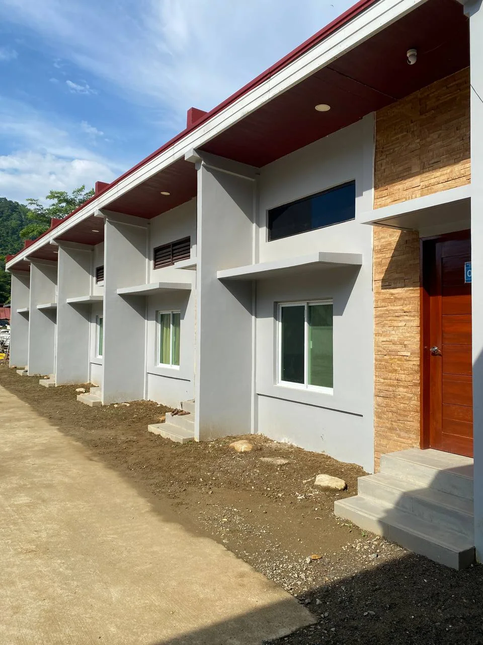 Individual staff rooms opening onto a shared outdoor walkway